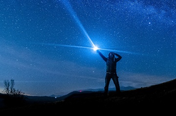 long exposure of flash light pointed toward night sky