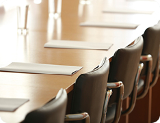 boardroom with printed agendas at empty seats
