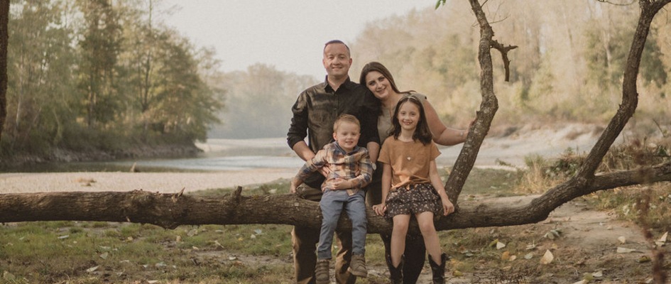 Katie Six and her family near a river bank.