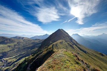 View across top of mountain range on clear day