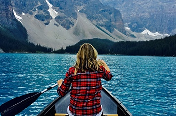 lake canoeing, mountains behind