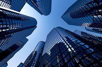 Looking skyward between glass-sided skyscrapers