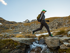woman hiking through rocky terrain