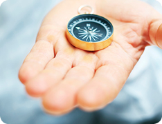 hand holding a compass