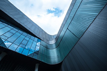 Looking upward along glass-sided building