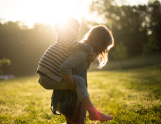 kid riding piggyback on sibling