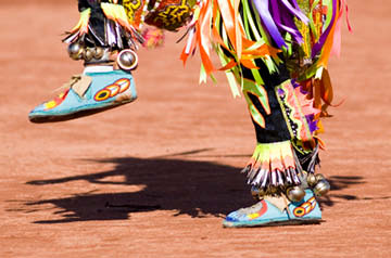 person dancing in colorful Indigenous garb