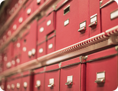 neatly organized shelves of red document letter boxes