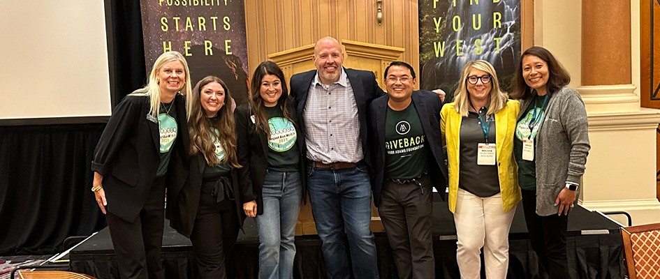 People posing for a photo at a conference