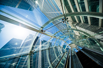 Looking skyward through glass ceiling while ascending stairs