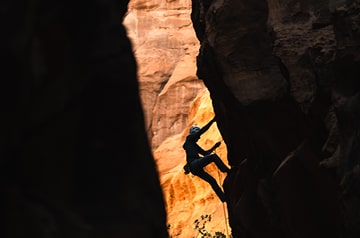 rock climber between cliffs