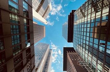 looking upward through skyscrapers