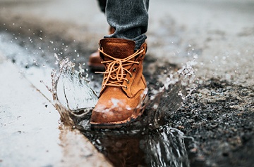 boot stomping in puddle