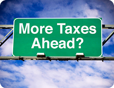 highway sign reading 'More Taxes Ahead?'