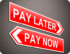 signs reading 'Pay Now' and 'Pay Later' pointing in opposite directions