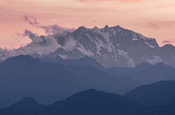 snowy mountain tops at sunset