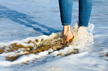 seafoam rushing over feet