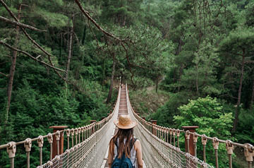 Hat woman sets off on bridge
