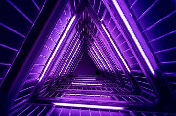 Glowing neon purple triangular geometric shape that recedes into background